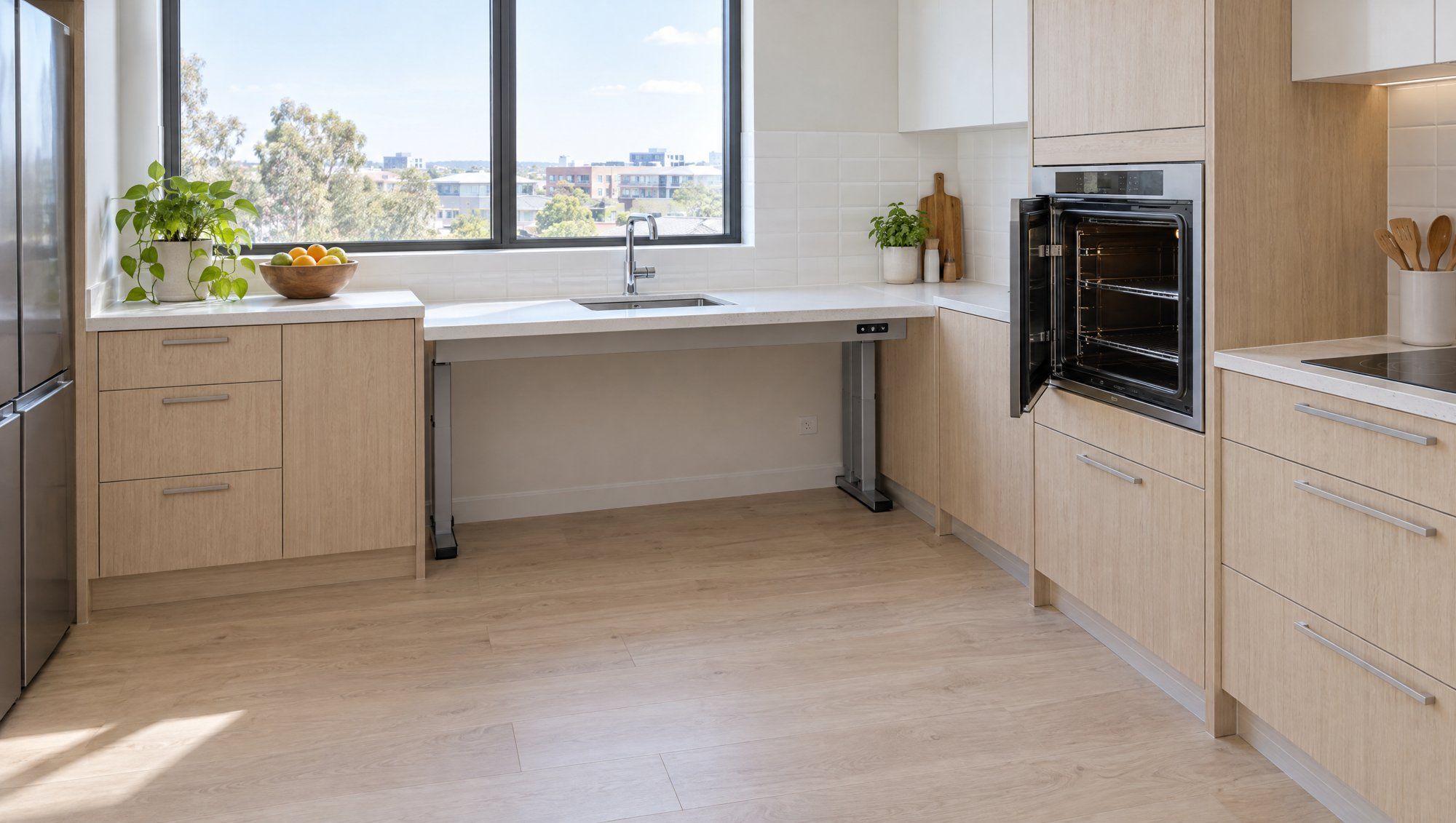 An accessible kitchen with a lowered height-adjustable bench, knee space and a side-opening oven