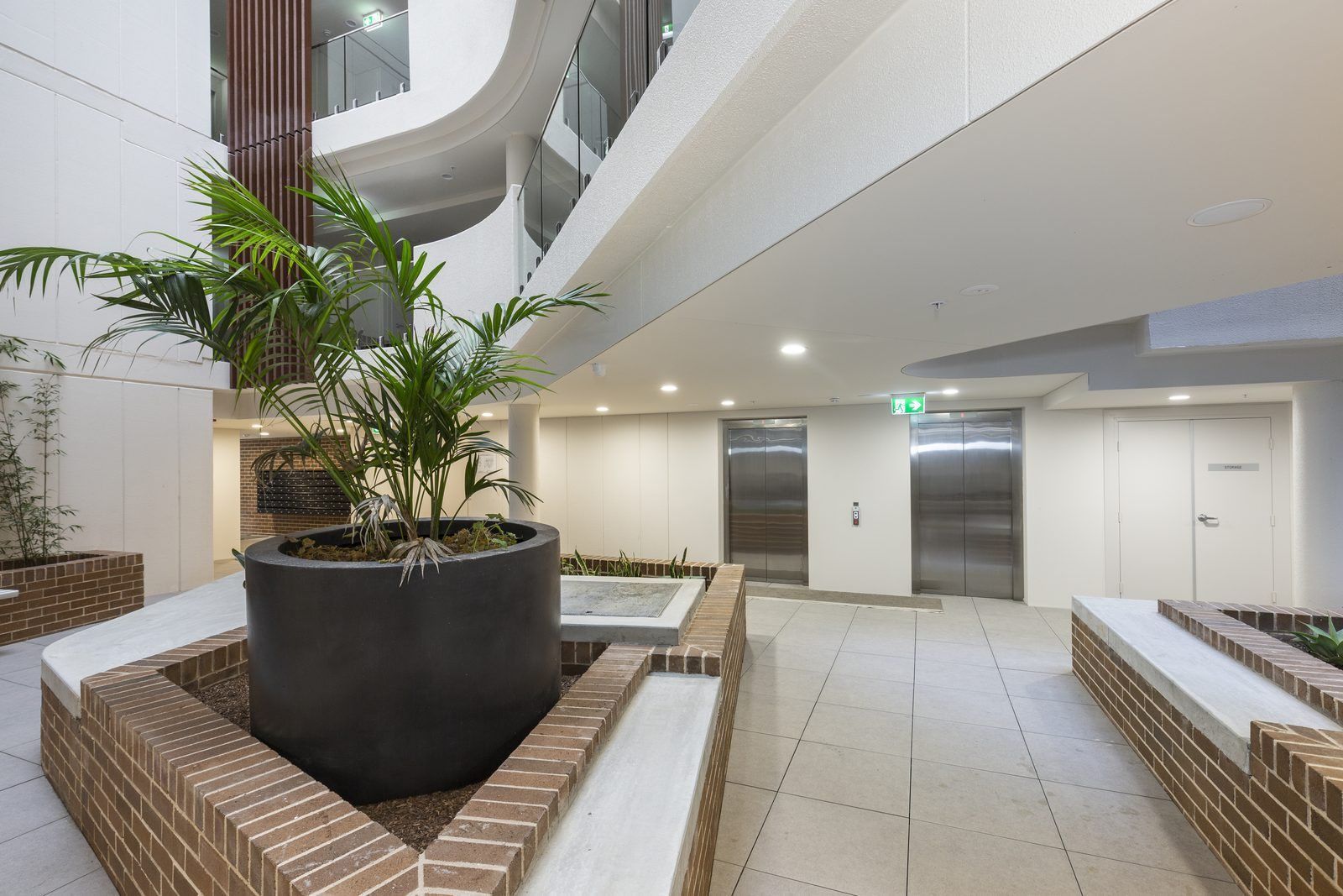 Photo 7 of 8: Ground-floor garden with planters, palms and open walkways