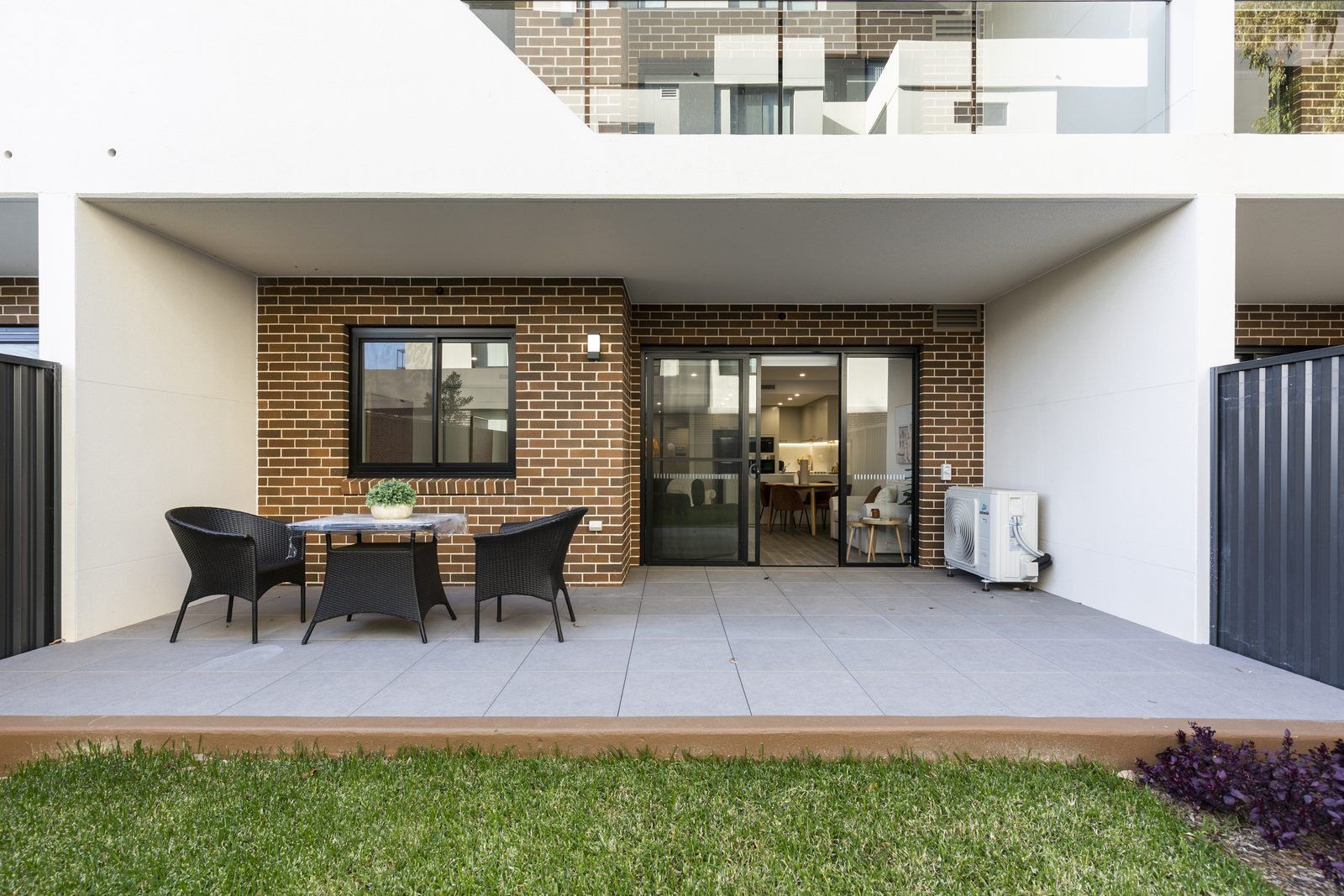 Photo 6 of 8: Private landscaped courtyard of a ground-floor apartment with an outdoor table
