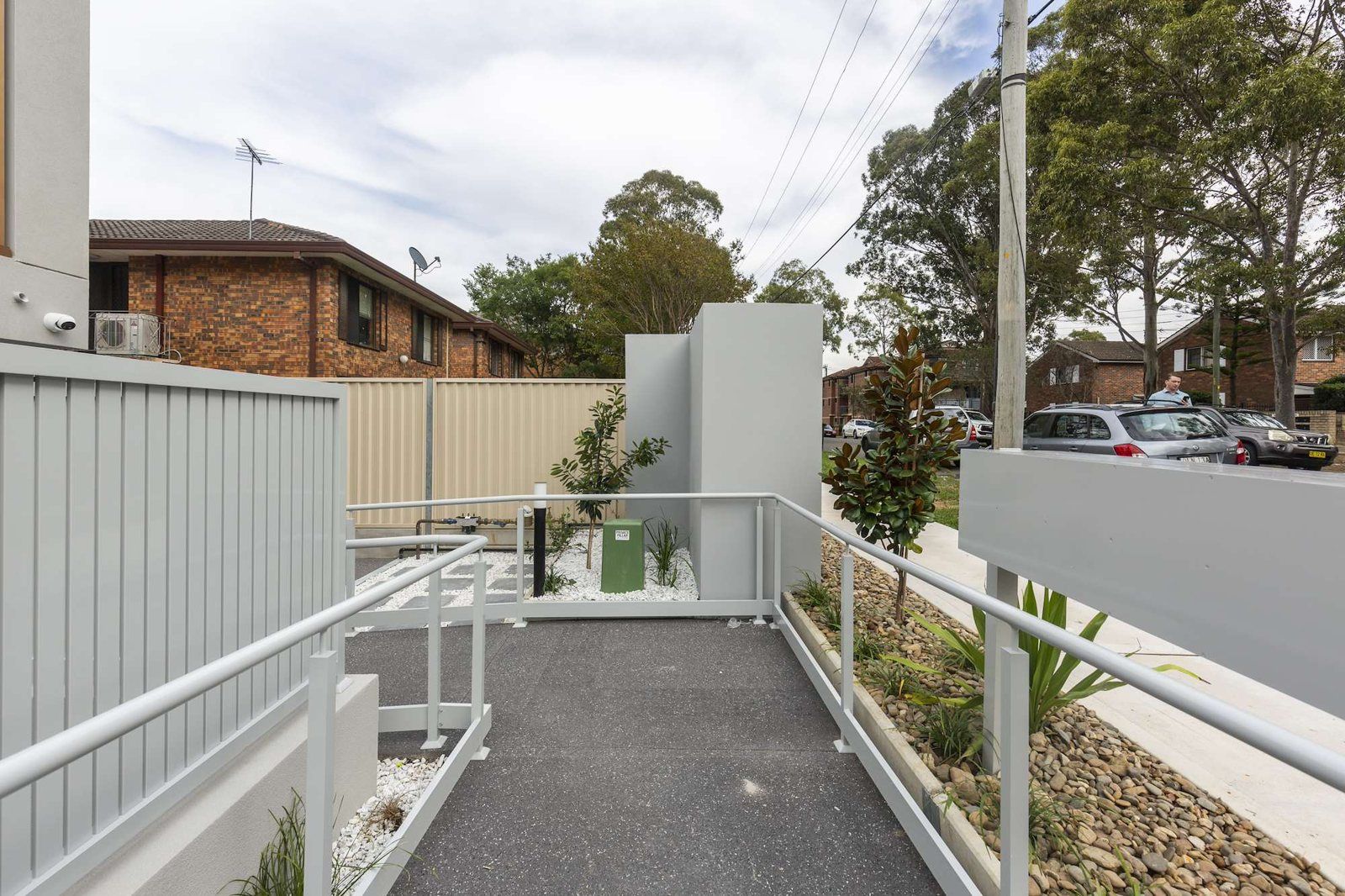 Photo 10 of 11: Ramped, step-free entry path with handrails leading to the building
