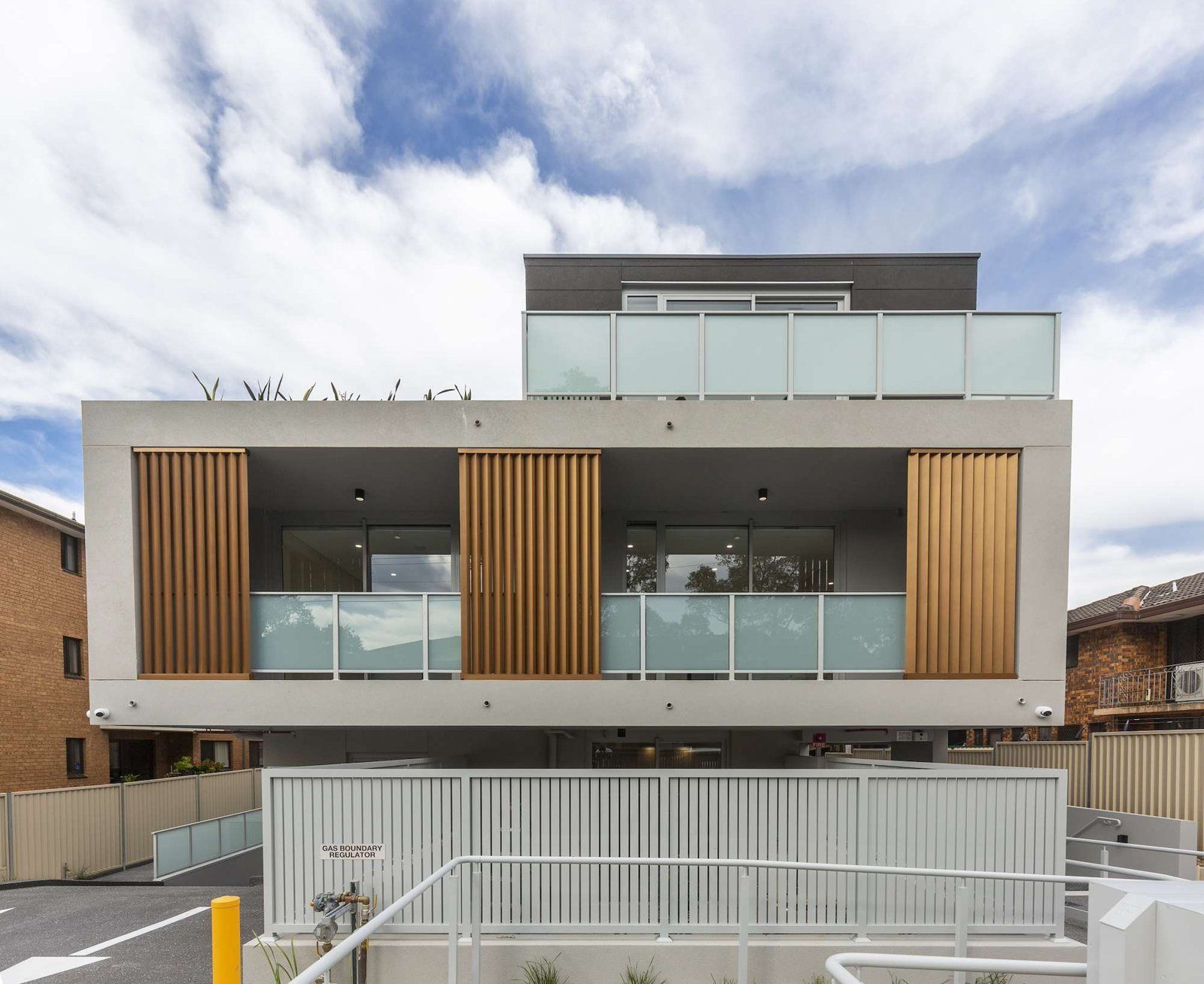 Photo 1 of 11: Modern four-level apartment building on Todd Street, Merrylands, with timber screens and glass balconies