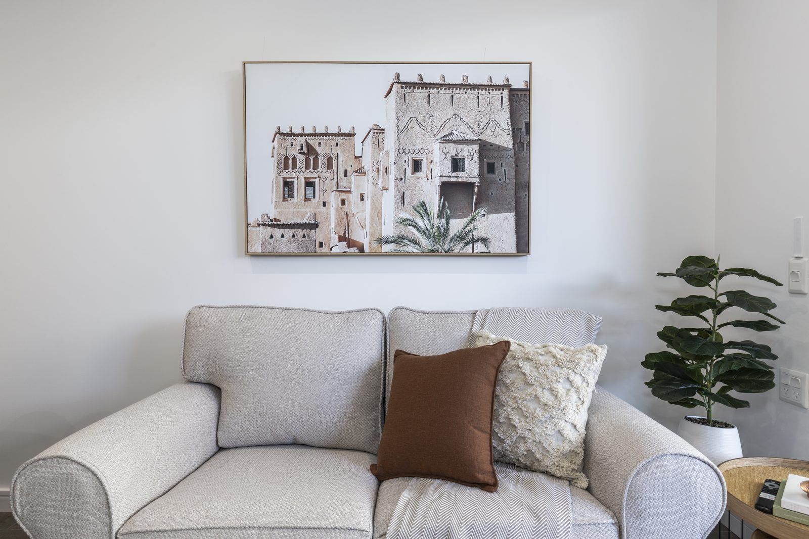 Photo 5 of 8: Living room with a cream sofa, artwork and an indoor plant